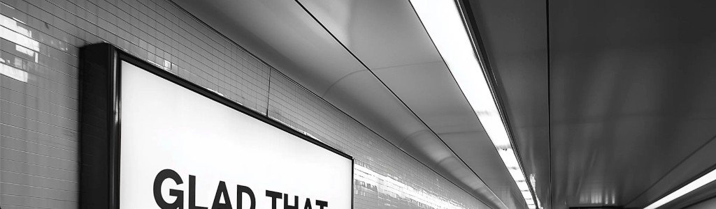 Underground passage with tiled walls and illuminated billboard